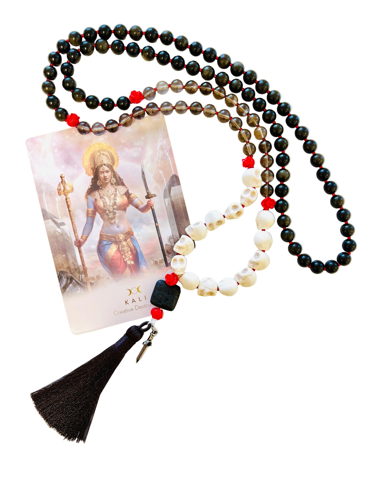 Golden sheen obsidian beaded mala necklace with red flower beads and skull beads and a tassel on a white background